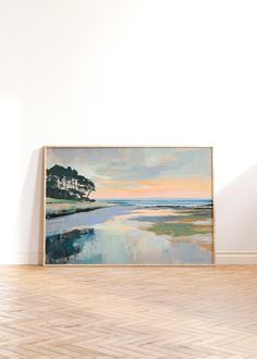 an empty room with a painting on the wall and hard wood flooring in front of it