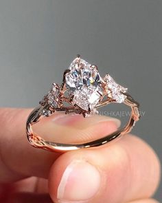 a person holding a diamond ring in their hand