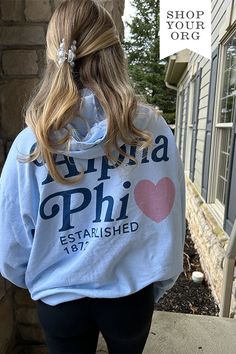 the back of a woman's hoodie with an image of a heart on it