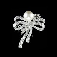 PERFECT CHRISTMAS GIFT LADY !!  PERFECT GIFT /WEDDING GIFT FOR BRIDE / BRIDESMAID / LADY! Great Accent for your Wedding Dress! This sparkling PEARL Bow Flower Brooch made with Swarovski crystals measuring 1 3/8" wide X 1 5/8" high (35mm X 42mm). Great piece for your collection! Prices are in US$. For shipping policies and other important information, click on "profile" on the right. See an item that you like but has already been sold? Contact me to see if I have more! Thank you for stopping by K Elegant Bouquet, Pearl Bow, Bow Brooch, Floral Pins, Wedding Gifts For Bride, Wedding Brooch, Wedding Bridal Jewellery, 50th Birthday Gifts, Jewelry Christmas