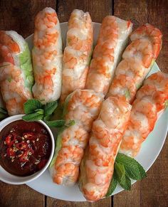 shrimp sticks with dipping sauce on a white plate