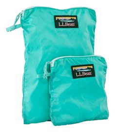 two blue bags with the label l l bean on each one and an empty bag behind them