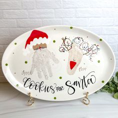 a white platter with santa and reindeers on it