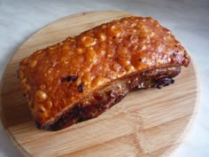 a piece of meat sitting on top of a wooden cutting board