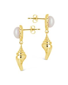 Elevate your style with our Beverly Drops Studs. These exquisite drop earrings feature a delicate combination of shells and pearls, creating a luxurious accessory that will effortlessly elevate any outfit. Make a statement of elegance and sophistication with the Beverly Drops Studs. Material: 14K gold or rhodium plated brass, freshwater pearls Features: 1.2" drop, 0.45" stud, 0.75" charm, 8mm pearls, Lead & Nickel free, post back Elegant Shell-shaped Pearl Earrings, Elegant Shell Pearl Earrings For Gift, Elegant Shell-shaped Pearl Earrings For Wedding, Elegant Shell Earrings For Gifts, Elegant Gold Shell Pearl Earrings, Shells And Pearls, Solid Gold Bracelet, Solid Gold Earrings, Statement Drop Earrings