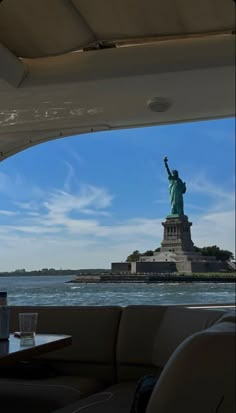 the statue of liberty is seen from inside a boat