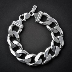 A handmade sterling silver 925 massive and heavy chain link bracelet.Each bracelet is cleaned and polished with care.The weight of the bracelet may vary according to size.Approx. weight: 97grChain link witdh: Approx. 18mmChain link thickness: Approx. 5.6mmThe bracelet is made of sterling silver 925 and is water resistant.All of our chain link products go through the same process. Full oxidization, cleaning and polishing/brushing. The oxidization (blackening) is left in the cracks and in between Modern Silver Cuban Link Bracelet With Chunky Chain, Sterling Silver Chunky Chain Bracelet, Classic Silver Cuban Link Bracelet With Chunky Chain, Silver Bracelets With Chunky Oval Link Chain, Silver Oval Link Chunky Chain Bracelet, Silver Link Bracelet With Chunky Chain, Silver Cuban Link Bracelet With Chunky Chain, Silver Chain Bracelet With Chunky Links, Silver Chunky Chain Link Bracelet