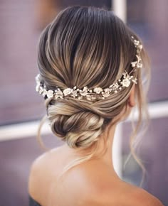 a woman wearing a bridal hair comb with flowers in her hair