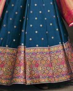 COLOR : Blue & Pink FABRIC : Jacquard Banarasi Silk WORK : Woven Zari & Thread Work, Resham Embroidery (around neckline), Tassels (on dupatta), Lace Border OCCASION : Wedding, Reception, Festival, Party Wear, Sangeet READY-TO-WEAR : NoSTITCHING : Available as semi-stitched fabric, can be stitched using standard size option (+$20). Note: There might be a slight color variation due to lighting and flash used during photoshoot. The bright shade seen is the best closer view of fabric's color. Semi-stitched Banarasi Silk Dress With Pallu, Traditional Blue Gown With Pallu, Traditional Blue Gown With Traditional Drape, Traditional Blue Gown With Drape, Traditional Blue Gown For Festivals, Traditional Blue Gown With Zari Work, Diwali Semi-stitched Dress With Traditional Patterns, Art Silk Dress For Eid And Traditional Ceremonies, Traditional Blue Maxi Length Lehenga