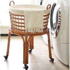 a laundry basket sitting next to a washing machine