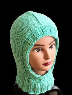 a mannequin head wearing a green knitted hat