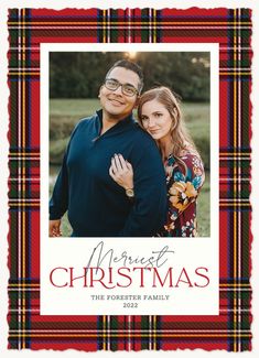 a christmas card with an image of a man and woman hugging in front of a plaid background