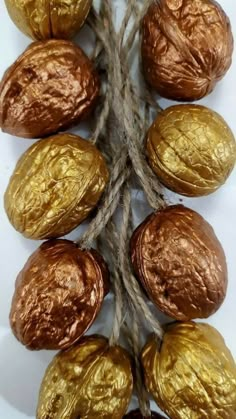 some gold foiled chocolate eggs are on a rope