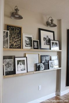 the wall is filled with pictures and framed photos