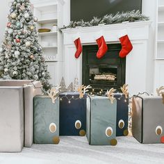 christmas presents are lined up in front of the fireplace