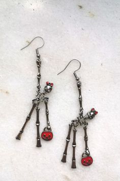 Elegant red bag lady skeleton earrings. Creepy but sweet, scarry but cute, frightening but happy... These earrings make you smile and add C-class horror movie look to your outfit. Check it and test how addictive skeletons earrings might be #skullmakeup #skullart #skullhead #skulljewelry #skullearrings #skulladdict #skulladdiction #earringsforsale #etsyearrings #halloweencostume #halloweenjewelry #halloweenearrings Spooky Red Halloween Jewelry, Red Novelty Jewelry For Halloween, Red Metal Halloween Earrings, Red Halloween Earrings, Red Earrings As Halloween Gift, Red Earrings For Halloween Gift, Fun Red Jewelry For Halloween, Red Fun Halloween Jewelry, Fun Red Halloween Jewelry