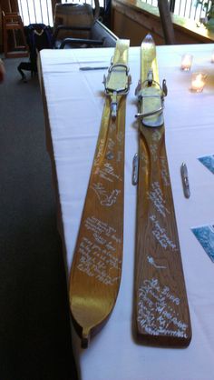 two skis sitting on top of a table next to each other with writing on them