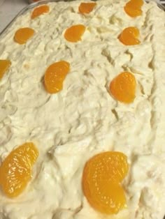 an uncooked cake with oranges on it