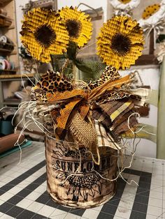 some yellow flowers are in a bucket on a table with black and white checkered flooring