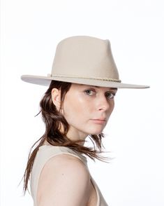 The White Felt Hat is an updated version of Maxi Bionda. It comes in mulseing-free wool produced in our 200-year-old hat factory. The edge is cut, brim is shapeable and has an inside size-adjustable strap. The hat is decorated with a handmade twisted strap in the color beige. Attached on the right-hand side is our white signature pearl. Unisex. Felt Hat, Wide Brimmed, Hat Sizes, The Edge, Wool Felt, The White, Adjustable Straps, Felt, Things To Come