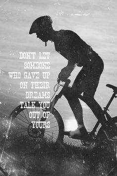 a black and white photo with a person riding a bike in the water, saying don't let someone who gave up on their dreams take you out of yours