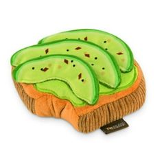 a stuffed animal with slices of avocado on it's back and sides