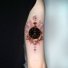 a person with a tattoo on their arm has a clock and stars tattooed on it