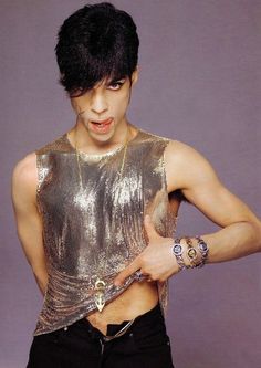 an image of a man with tattoos on his chest and shirt that has gold sequins on it