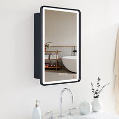 a bathroom with a sink, mirror and towel rack on the wall next to it