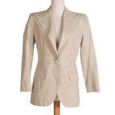 Sleek beige blazer by Dolce and Gabanna. Comes with front pockets and single button at center. You are buying the blazer and getting the pants thrown in for free (See more info below). Measurements - Top  Bust: 36" Waist: 32" Length: 29" Shoulder-to-Shoulder: 16" Sleeve Length: 23" Measurements - Pants  Waist: 30" Hips: 40" Inseam: 28" Rise: 9" Leg Opening: 16" Condition: You are buying the blazer and getting the pants thrown in for free to try to stain treat or donate at your discretion. Some s Cream Sport Coat With Lapel Collar For Work, Tailored Beige Blazer With Flat Front, Cream Sport Coat With Notch Lapel For Workwear, Cream Blazer With Hidden Button For Business Casual, Neutral Blazer With Welt Pockets For Office, Beige Cotton Office Blazer, Office Beige Cotton Blazer, Beige Cotton Suits For Workwear, Cream Single Breasted Office Blazer