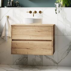 a bathroom vanity with a sink and towel hanging on the wall next to it's mirror