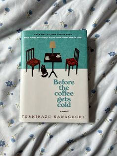 the book before the coffee gets cold by toshizu kawaguchi is laying on a bed