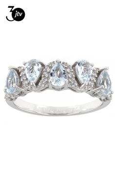 a white gold ring with pear shaped blue topazts and diamonds on the sides