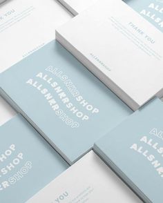 several blue and white business cards stacked on top of each other with the words almshop