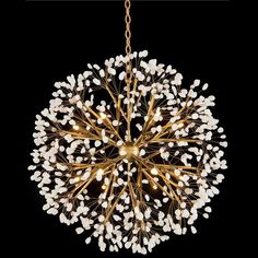 a chandelier with white flowers hanging from it's center, on a black background