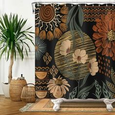 a shower curtain with flowers and leaves on it in front of a potted plant