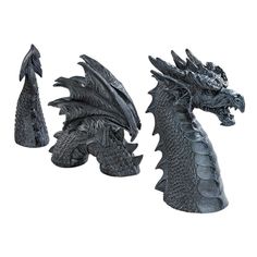 two black dragon figurines sitting next to each other on a white background,