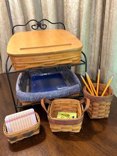 a wooden table topped with two baskets filled with pencils