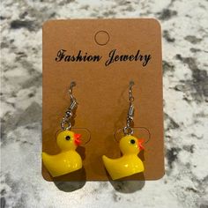 a pair of yellow rubber ducky earrings