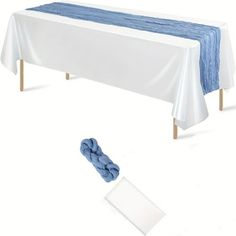 a blue and white table cloth sitting on top of a table next to a roll of yarn