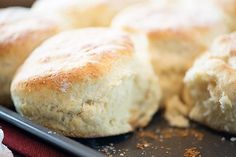 closeup of bread rolls on a baking sheet with a red towel and napkin in the background