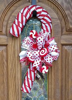 a red and white candy cane wreath on a door