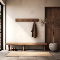 a wooden bench sitting under a window next to a potted plant and coat rack