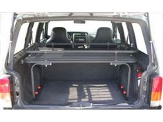 the back end of a vehicle with its cargo compartment open and two seats folded down