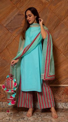 PRODUCT DESCRIPTION: Kurta : Cotton Pants: Cotton Dupatta: Organza No. Of Components : Set of 3 Length of kurta: 40inches Length of pants: 38inches Length of dupatta: 2.50 meters Margin left: 2inches Wash Care : Dry Clean Customization : Only Size and Length Of Product SKU#: 11403078BL Disclaimer: All our pieces are handcrafted in our manufacturing unit .We Ensure that our pieces are shot professionally under controlled lighting. Colours tend to be perceived differently depending on factors such Festive Blue Pant Set, Turquoise Salwar Kameez With Dupatta, Traditional Light Blue Sets For Summer, Traditional Light Blue Set For Summer, Traditional Light Blue Summer Set, Festive Turquoise Sharara, Blue Cotton Pants For Festive Occasions, Festive Turquoise Sets For Summer, Fitted Blue Cotton Palazzo Set