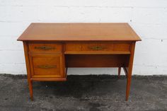 an old wooden desk with two drawers on the top and one drawer at the bottom