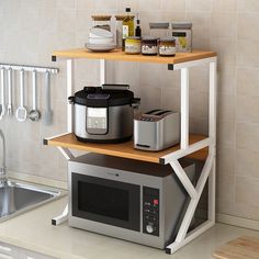 a kitchen with a microwave, crock pot and other items on the counter top