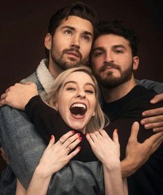 two men and a woman hugging each other