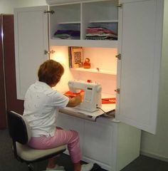 a woman sitting at a desk with a sewing machine