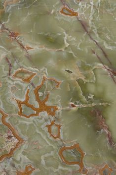 an abstract marble pattern with orange and green colors